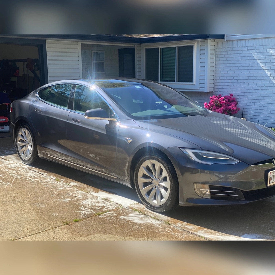Freshly detailed Tesla Model S in a customer driveway